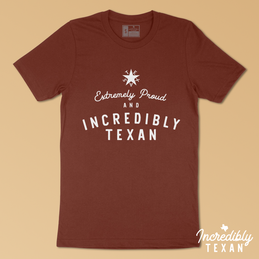 A dark rusty red short sleeve t-shirt that says "Extremely Proud & Incredibly Texan" printed in white with the Zavala Texas star above.